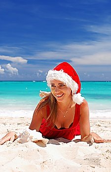 Woman on the beach in santa´s hat