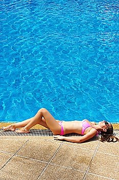 Girl at tropical swimming pool
