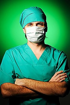 Surgeon in mask over green