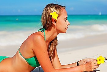 Girl with flower on caribbean beach