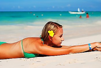 Girl with flower on caribbean beach