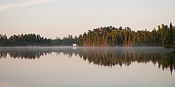 Reflection of trees in water, Lake of the Woods, Ontario, Canada