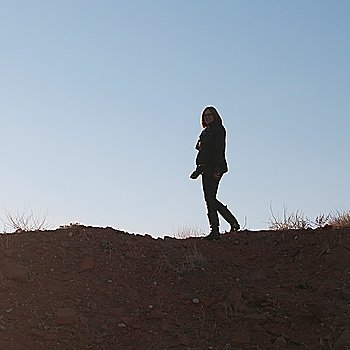Woman walking on rock, Utah, USA
