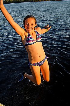 Girl jumping into a lake, Lake of the Woods, Ontario, Canada