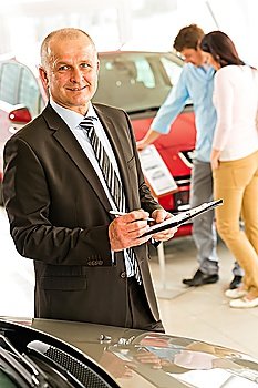 Closeup portrait of salesman working in car dealership