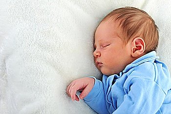 Newborn cute baby sleeping on white blanket