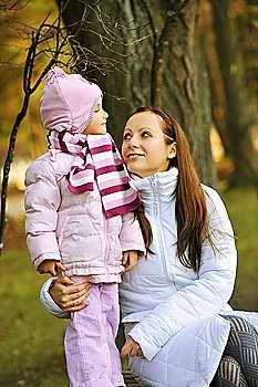 Mother and daughter in autumn  park