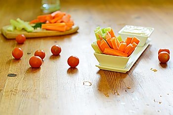 fresh celery sticks, carrot and blue cheese sauce on wooden background