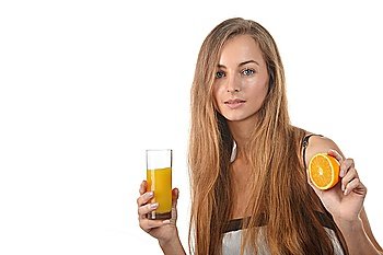 beautiful young blond  woman with  half of orange and glass of juice  in her hands