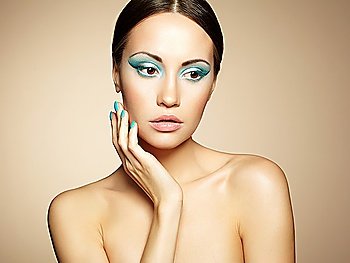 Beautiful young woman with bright make-up and manicure. Beauty fashion