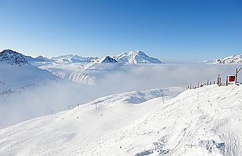 Mountains in clouds with snow in winter, Val-d´Isere, Alps, France