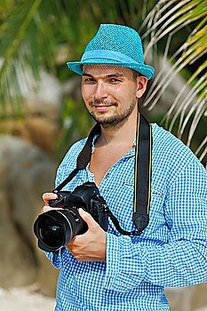 Man on a beach with camera