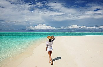 Woman in sun hat at tropical beach