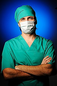 Surgeon in mask over blue