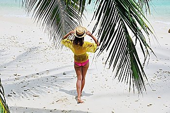 Woman at beach wearing hat