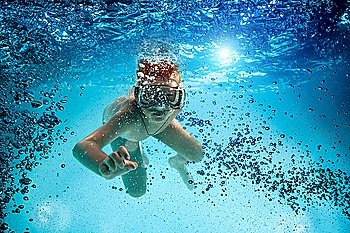 Freedive. Teenager in the mask and snorkel swim underwater.