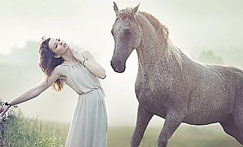 Attractive brunette woman and spotted horse