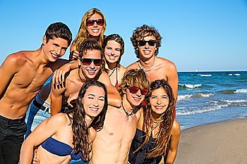 Happy teenagers young group together on beach in summer vacations