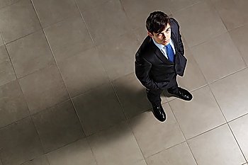 Young businessman looking above