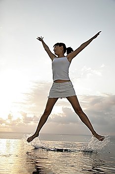 Young woman jumping spreadeagled