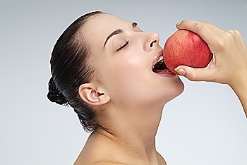 Close-up of young woman holding an apple