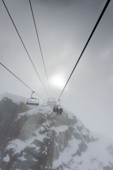 Ski lifts over snow covered mountain in foggy weather, Whistler, British Columbia, Canada