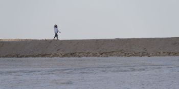 Woman walking on beach, Dead Sea, Israel