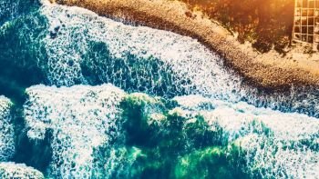 Bird’s eye view on the open waters of planet earth, stormy seas, blue turquoise water of an ocean with waves and foam, abstract natural background, drone photography. Beach background