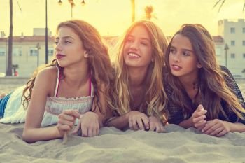 Best friends girls at sunset beach sand smiling happy together filtered image