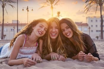 Best friends girls at sunset beach sand smiling happy together