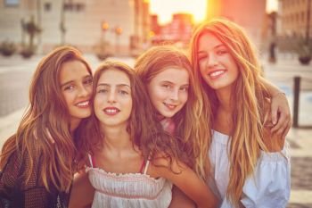 Best friends teen girls at sunset in the city filtered image