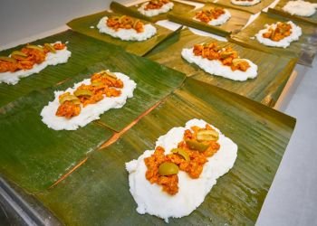 Tamale preparation Mexican recipe with banana leaves and cornmeal