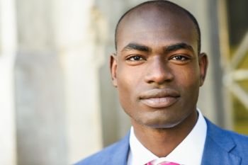 Portrait of handsome black man wearing suit in urban background