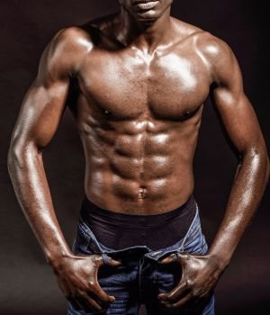 Portrait of an athletic black man on black background