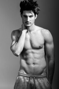 Portrait of half naked sexy body of muscular athletic man. Studio shot
