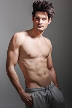 Portrait of half naked sexy body of muscular athletic man. Studio shot
