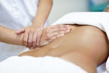 Hands massaging female abdomen.Therapist applying pressure on be. Hands massaging female abdomen.Therapist applying pressure on belly. Woman receiving massage at spa salon