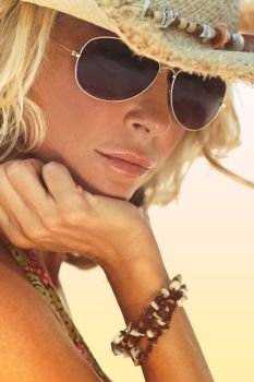 Stunningly beautiful and sexy young blond woman in straw cowboy hat and sunglasses 