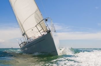 Close up of sailing boat, sail boat or yacht at sea on summera€™s day with blue sky