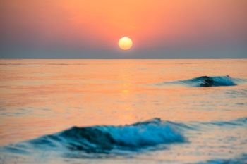Sunset on the beach with long coastline, sun and dramatic sky . Sunset on the beach with long coastline