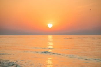 Sunset or sunrise over sea with sun on beautiful dramatic sky. Sunset or sunrise over sea