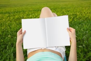 Magazine of in a lap reading person against a field. Rest with reading 