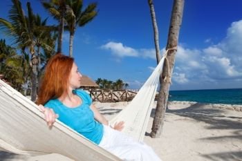 woman in hammock on background of ocean and sky