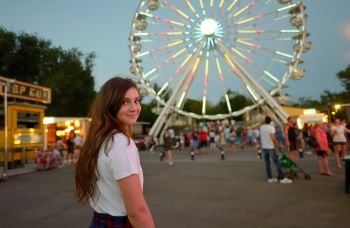 Teen girl in amusement park in summer