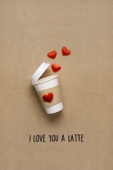 Creative concept photo of take away coffee cup with hearts on brown background.