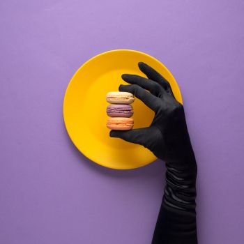 Creative concept photo of kitchenware with hand, painted plate with food on it on purple background.