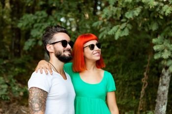 Young couple of lovers with sunglasses in the park