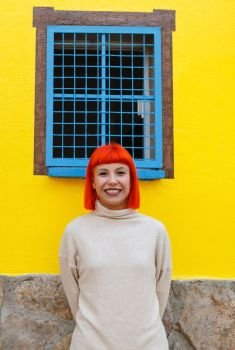 Attractive girl over a yellow house with funny windows