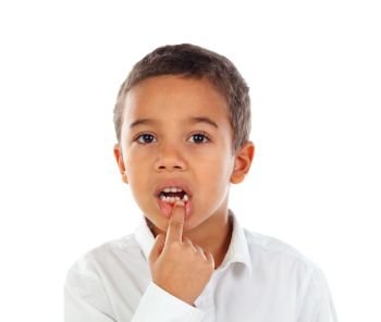 Latin child showing his new teeth isolated on a white background