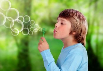Blonde child blowing and doing bubbles . Blonde child blowing and doing bubbles in a park
